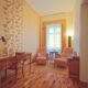 Suite living area with work desk and lounge chairs, SKARITZ Hotel Bratislava